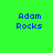 Pixelated blue text "Adam Rocks" on a bright green background with a subtle orange glow effect in the lower-left corner.
