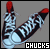 Pixelated image of two sneakers with red tips and checkered patterns, labeled 'CHUCKS' in white text on left and red text on right.