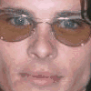 nine shows a person with brown hair and light blue eyes wearing brown-tinted sunglasses, transitioning from close-up to medium shots