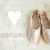 A pixelated image shows a white heart shape on the left and two brown figures with light-colored clothing on the right against a pale background.