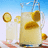 Pixelated image of a pitcher with lemon slices and two glasses on a checkered surface, next to orange with yellow text