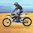 Pixelated animation of a motorcyclist riding across sandy terrain under a light blue sky.