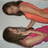 Two figures in a pixelated image: one in orange top and white shorts, the other in pink top and dark shorts, both with dark hair, positioned in a dynamic pose against a light gray background.