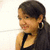 Pixelated close-up of a person with short dark hair wearing a black sleeveless top, set against a light background with subtle pixel noise.