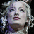 Pixelated image of a woman with curly blonde hair and red lips, next to blue text reading "I love Laura Michelle Kelly" on black background.