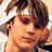 Pixelated close-up of a person's face with brown hair and light skin tone, static single-frame image.