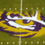 Pixelated static image of a stylized yellow and purple object with white accents on a green background, resembling an abstract or cartoonish design.