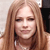 Pixelated close-up of a person with long light brown hair, closed eyes, and a neutral expression against a light background.