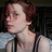 Static image shows a person with short brown hair in profile on left, and green pixelated figure holding object against red background on right.