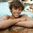 Pixelated image of a person with brown hair lying on a light blue surface, arms crossed over chest, next to text reading 'Ryan Sheckler' in black block letters.
