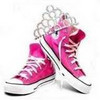 A pair of pink high-top sneakers with white laces and white rubber soles, positioned against a plain white background.