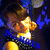 Pixelated anime-style character with brown hair and yellow shirt, blue background with white circles, blue text overlay, animated head movement.