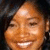 A smiling person with dark hair and light brown skin appears in a of four , showing variations in facial expression and background