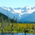 Pixelated landscape with blue sky, white clouds, green and brown terrain, and blue water at the bottom.
