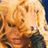 Pixelated static image of a person with light-colored hair and dark clothing against a bright background, rendered in warm tones at 256x256 resolution.