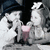 Two stylized figures in white and gray tones stand side-by-side against a dark background, one holding a pink object.