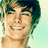 Pixelated portrait of a smiling person with brown hair on a light background, next to blue text reading Zachary, David Alexander, and Efron.