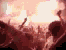 Animated sequence of silhouetted figures with raised arms against a bright, glowing background in warm red and orange tones.