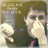 A person with short dark hair wearing a dark shirt and red tie points left with their right hand while covering their mouth with their left hand, with text overlay reading 'BILLIE JOE thinks YOU SUCK'.