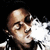 Pixelated image of a bald man with closed eyes exhaling white smoke against black background.