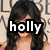 A pixelated image of a woman with long dark hair, partially obscured by text overlays reading 'holly', 'loves', and 'vanessa' across different sections.