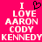 A static image with a bright pink background displays white pixelated text reading "I LOVE AARON CODY KENNEDY" in stacked lines, with a black heart symbol replacing the 'O' in LOVE.