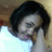 Pixelated close-up of a person with dark hair, light skin, and closed eyes against a blurred background.