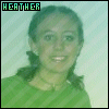 Pixelated portrait of a person with dark hair in low-resolution green and white tones, wearing a striped garment under a light background.