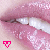 Close-up of lips with teeth visible, pink lip color and glittery texture, two small triangular icons at bottom left.