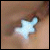 A pixelated light blue star-shaped icon with a white glow against a brownish background.