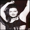 Black-and-white image of a person with long dark hair raising both arms, wearing a sleeveless top and necklace, with text changing across six