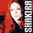 A 6-frame animated contact sheet of a woman with long red hair in various poses and expressions, each frame featuring vertical text reading "SHAKIRA" on the right side against colored backgrounds.