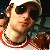 Pixelated static image of a person with dark hair wearing sunglasses and a red-and-white striped garment, set against a blurred background.
