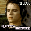 A person wearing large headphones with closed eyes, text reading 'music' at top and 'my escape from reality' below.