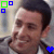 A pixelated image of a person with dark hair wearing a light-colored shirt, featuring colored square and heart symbols in the corners.