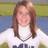 A pixelated static image shows a person with long brown hair wearing a white top and dark blue bottom, standing against a blurred background of green and blue tones.