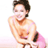 Pixelated static image of a shirtless person with dark hair wearing pink bottoms, smiling and holding an object near their waist against a white background.