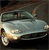 Static pixelated image of a light-colored vehicle with a dark roof and visible headlights, set against a dark background.