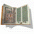 Animated sequence of an open book with green pages and brown cover, pages flipping left to right , followed by a black dog with white wings running left to right