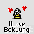 Pixel art character with white face and yellow body holding hands, surrounded by four red hearts on gray background, text below reads "ILove Bokyung".