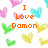 Pixelated image with orange text "I Love Damon" centered over a white background with scattered colorful heart shapes in pink, blue, green, and yellow.