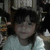 A child in a white shirt appears in a of four with slight variations in head position and background elements