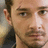 A pixelated close-up of a person's face with two distinct facial expressions, one side showing a neutral look and the other a slight smile.
