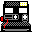 Pixelated black console with gray buttons and red accents, featuring yellow pixel clusters in top-right corner and bottom-left corner.