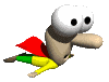 Animated character with large white eyes, brown body, red cape, green and yellow limbs in flying pose against gray background.
