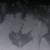 Pixelated grayscale image of a figure with a heart-shaped chest, overlaid with text reading "WOULD U WALK W/ME IN bha rain".