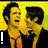 Two men in dark suits and orange ties embrace against a yellow background, while a blue below displays white text on a blue background