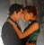 Animated sequence of two people kissing, with green text changing across frames from 'J' to 'Tommy'.