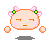 Pixelated character with peach skin, pink cheeks, and orange outline; two pink bows with green centers on head; four floating orange orbs around body.