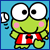 Pixelated green frog character with large white eyes, pink cheeks, and red-and-white striped outfit standing against light blue background with partial speech bubble.